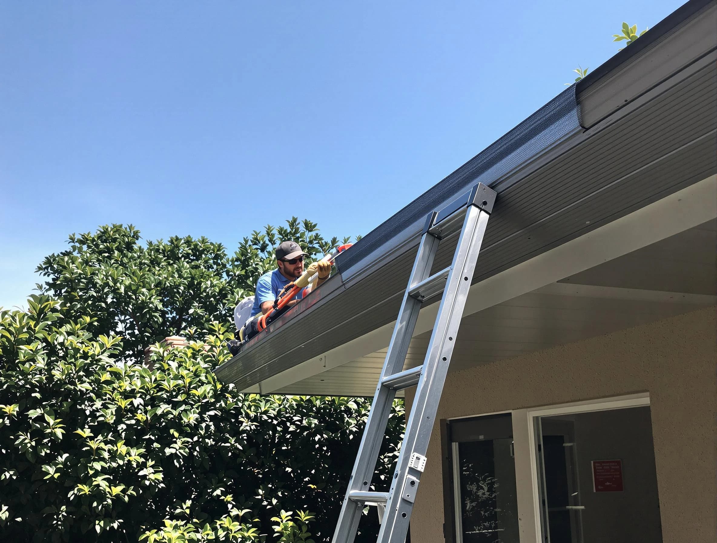 Lorain Roofing Company installing gutter guards for a homeowner in Lorain, OH